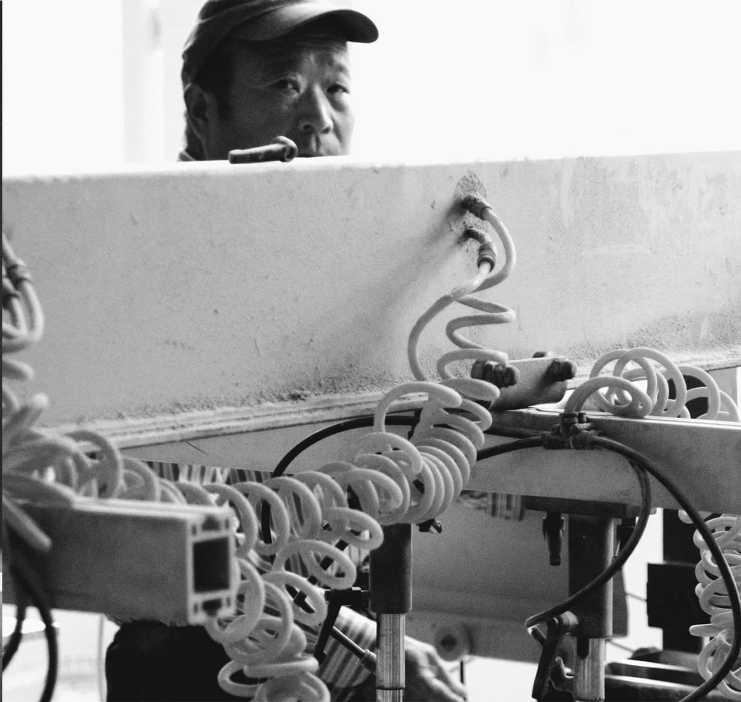 Worker operating an automatic multi-row boring machine